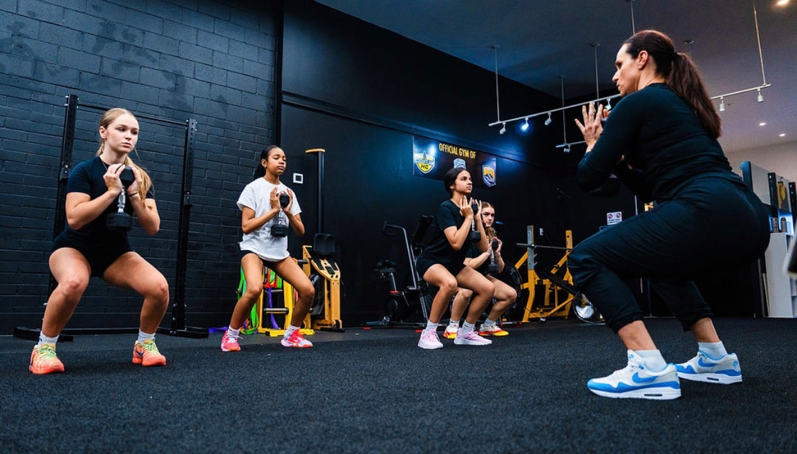 Group session: volleyball athletes training squats together at Capitol Hill Athletics.