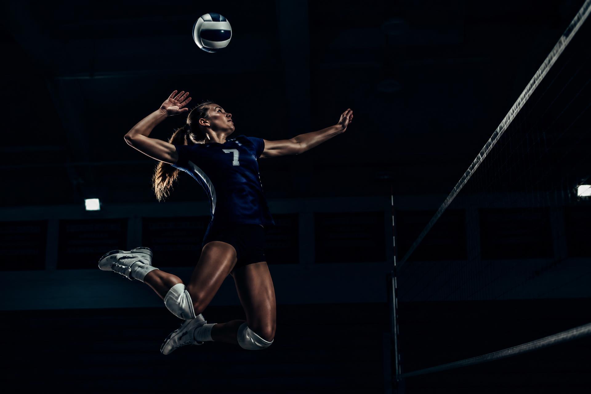 Volleyball athlete attacking at the net during a training session